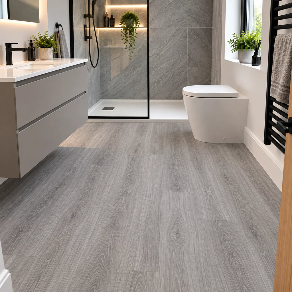 Grey oak effect waterproof LVT flooring in a modern bathroom with a walk-in shower and floating vanity unit