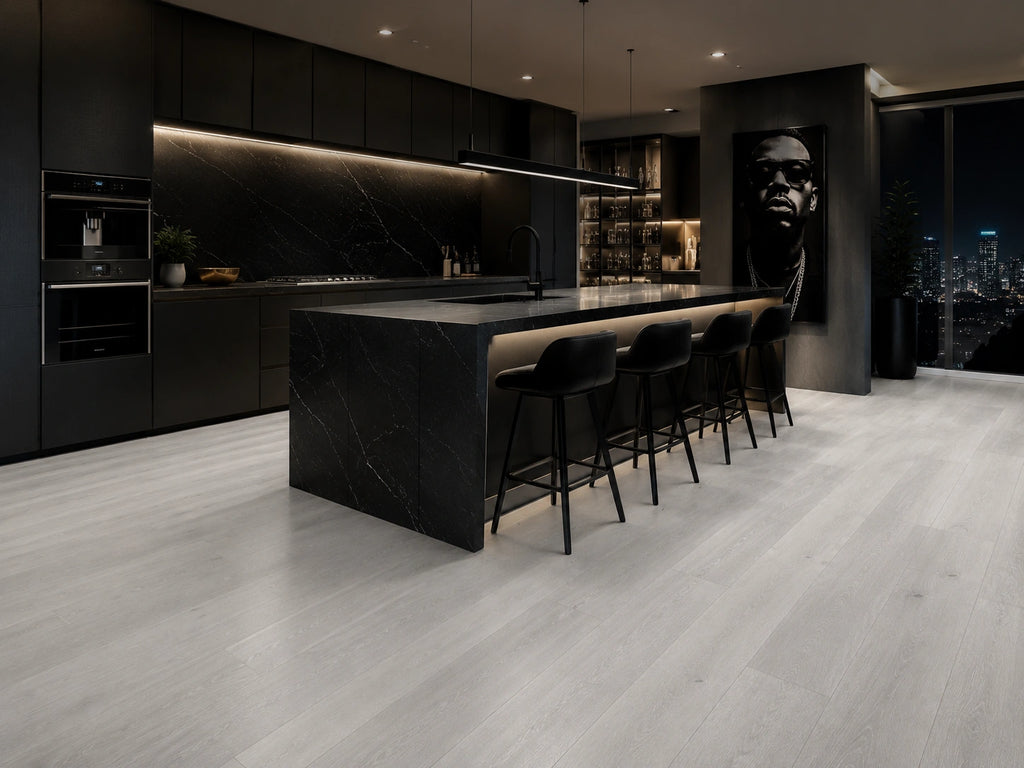 Grey Oak SPC flooring in a contemporary luxury kitchen with black marble breakfast island, under-cabinet lighting and floor-to-ceiling city views
