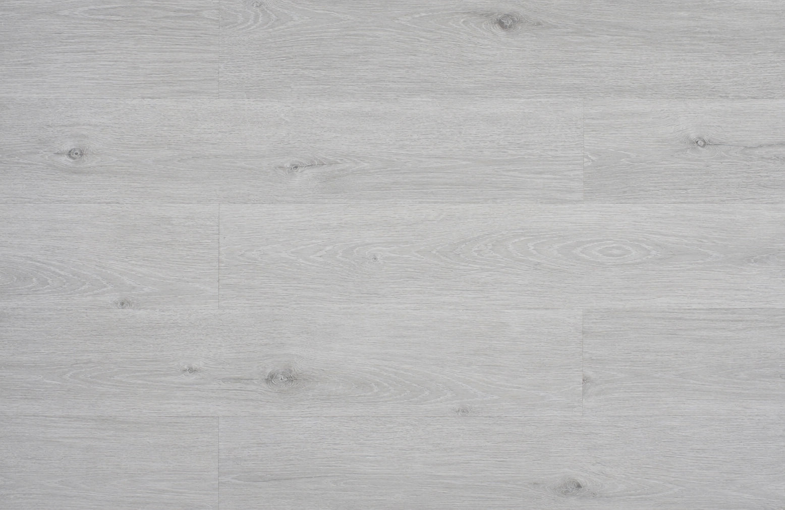 
Top-down flat lay of Grey Oak SPC planks showing pale silver-grey oak grain with subtle knot detail across full plank layout