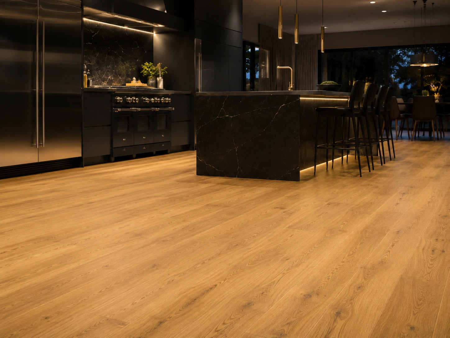 Harvest Oak SPC flooring in a high-end contemporary kitchen with black marble breakfast island, brass pendants and ambient under-cabinet lighting