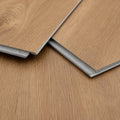 Close-up of two Maple Oak LVT flooring planks showing wood grain texture and click-lock edge

