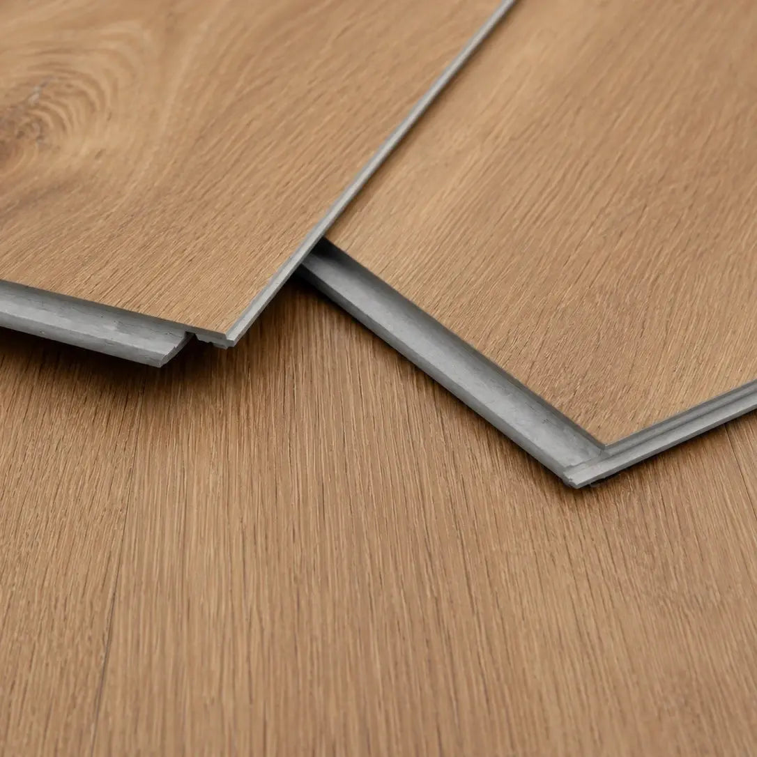 Close-up of two Maple Oak LVT flooring planks showing wood grain texture and click-lock edge
