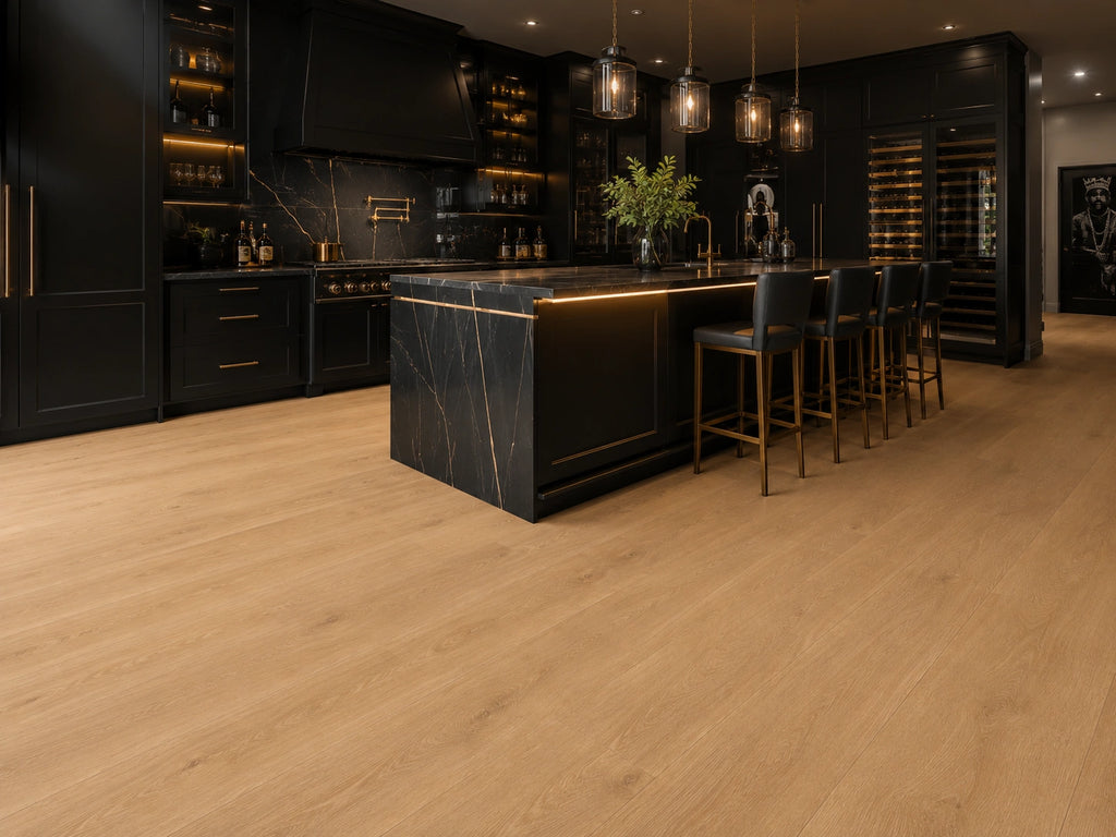 Maple Oak SPC flooring in a dramatic luxury kitchen with black and gold marble island, industrial pendant lights and illuminated cabinetry