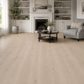 Pale oak SPC LVT flooring in a dark, evening-lit living room with linear fireplace and city view
